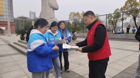 圖為普法志愿者向同學們發放法律宣傳手冊